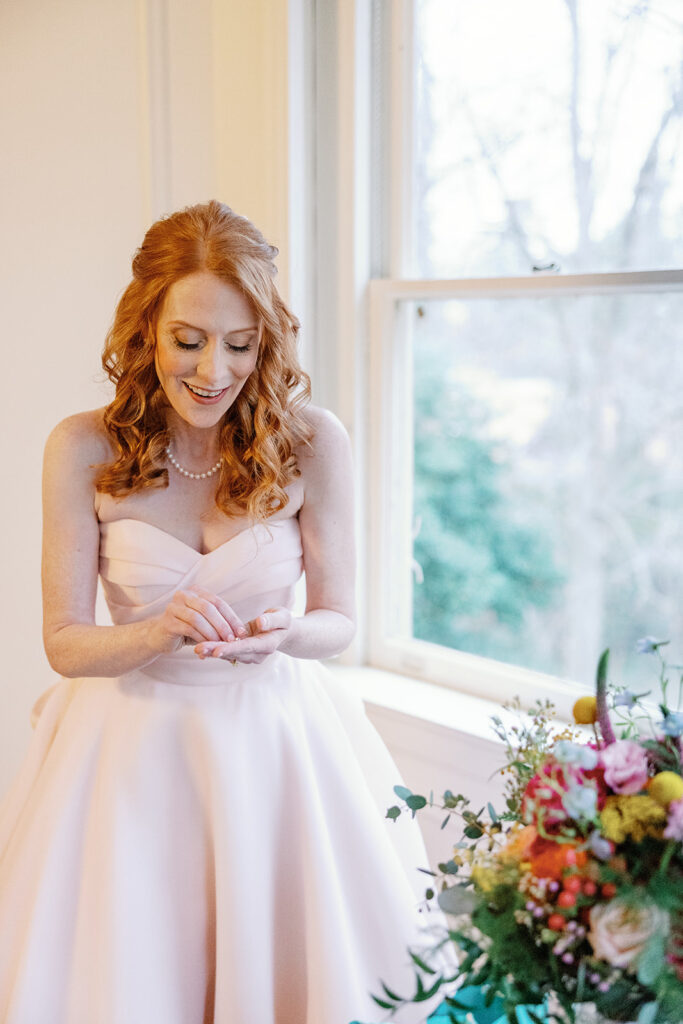 Bride getting ready and wearing pink wedding dress