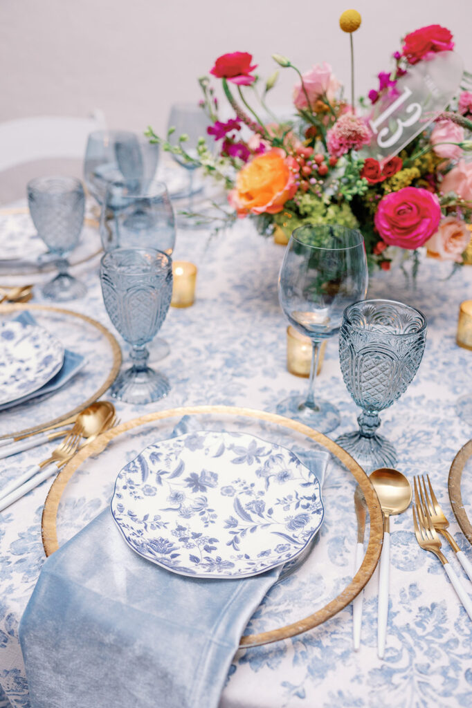 Toile table cloth with colorful floral centerpiece