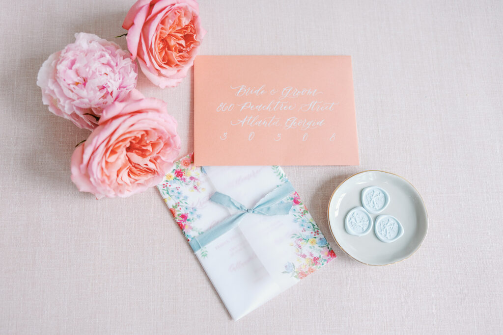 pink florals with custom wedding invitation and baby blue monogram wax seals