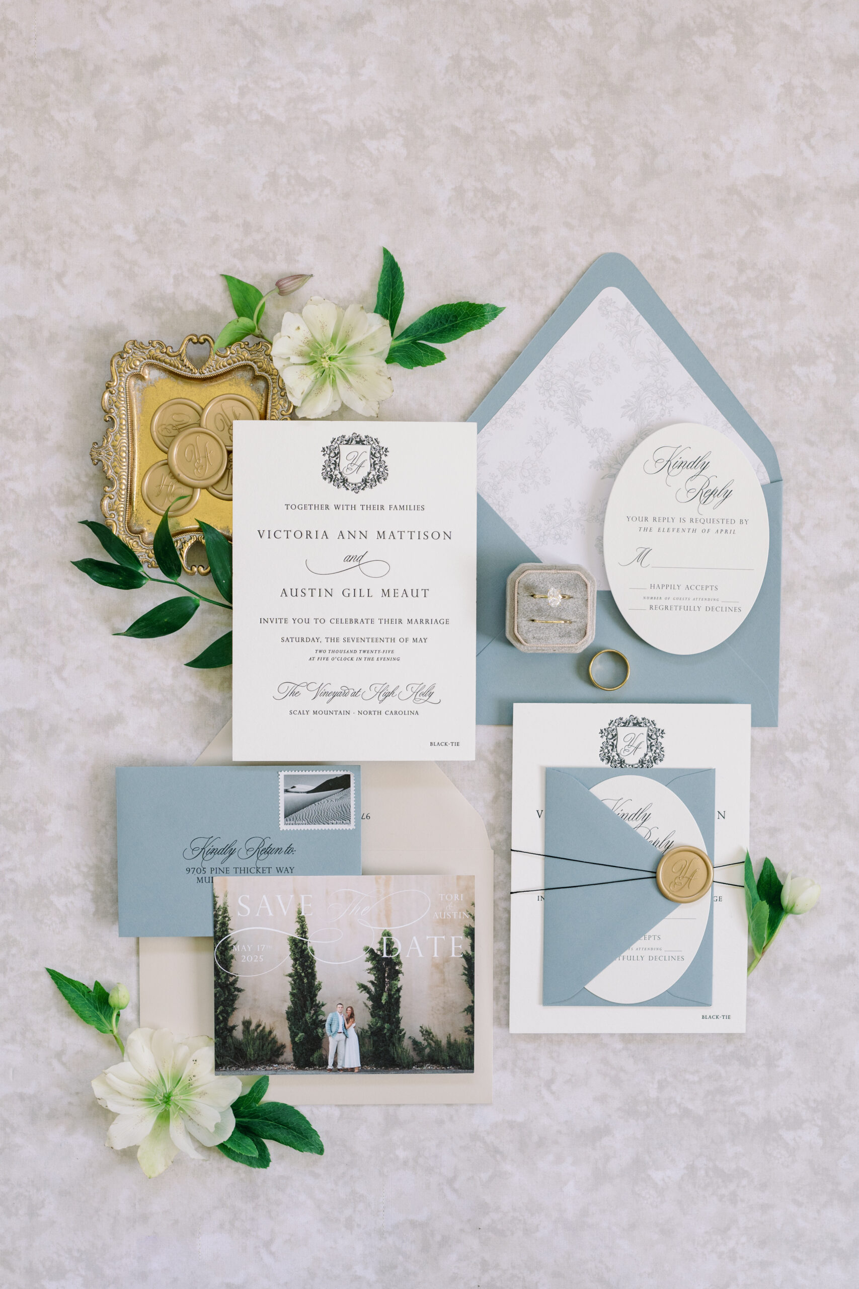 Flat lay of custom wedding invitation with wax seals and photo save-the-date