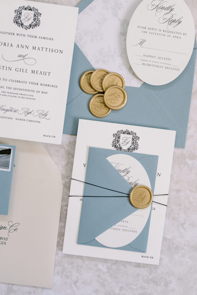 Elegant letterpress wedding invitation featuring tied band and wax seal