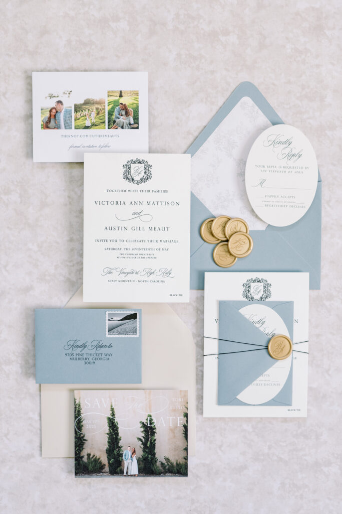 Flat lay of custom wedding invitations with wax seals and photo save-the-date