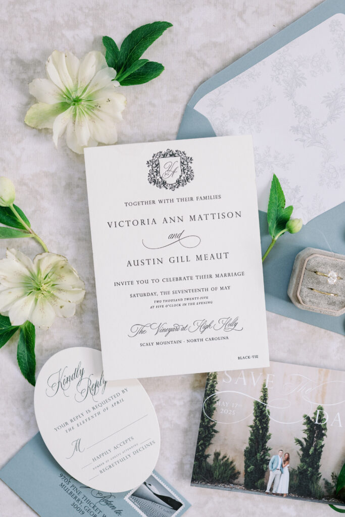 Elegant letterpress wedding invitation featuring custom monogram crest