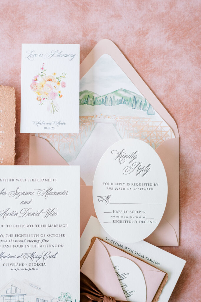 Deep brown letterpress wedding invitation with oval die cut reply card