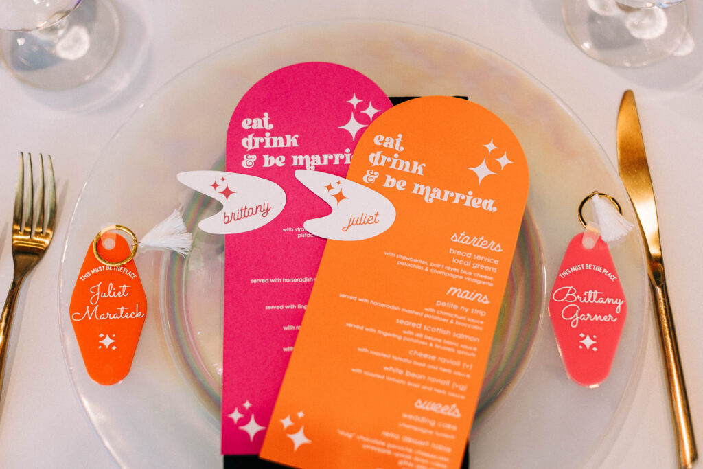 Colorful personalized wedding menus and escort keychains