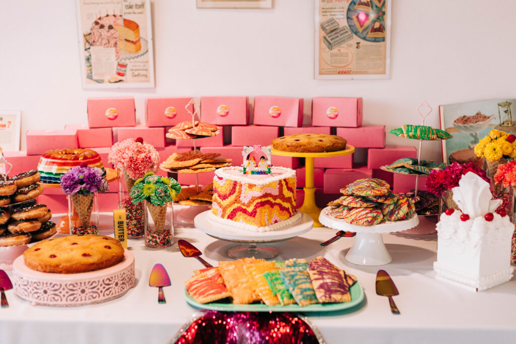 Retro dessert table at Ventanas with treat boxes and custom stickers