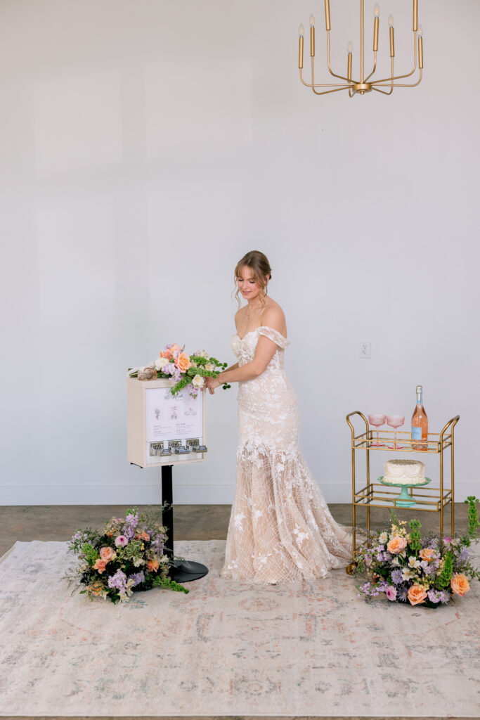 bride using wedding vending machine during cocktail hour